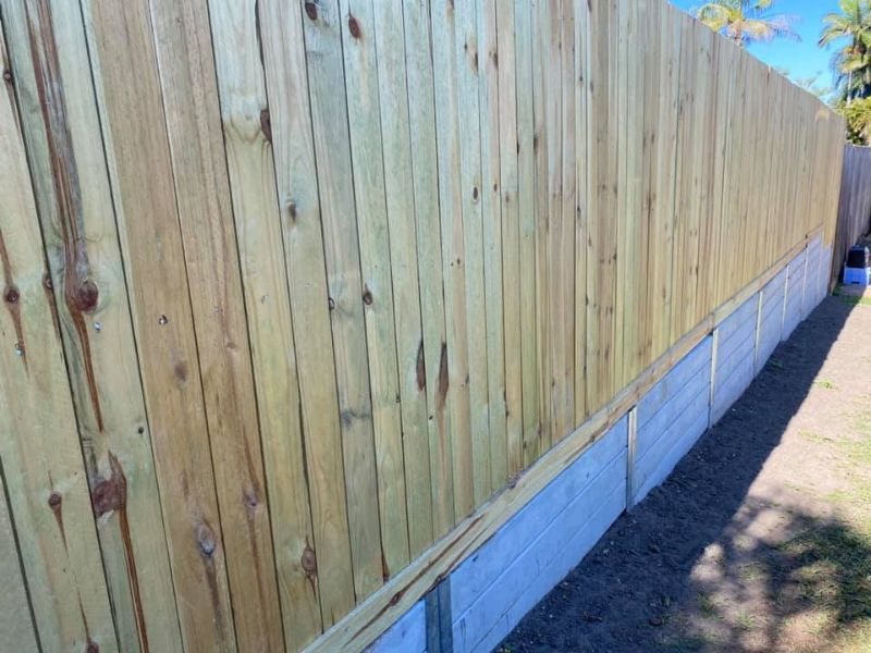 timber paling fence on concrete sleeper retaining wall